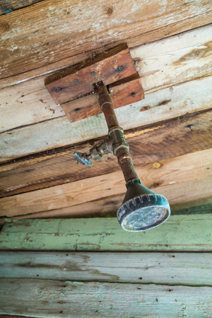 Shower in an old wooden barn in the country.の写真素材