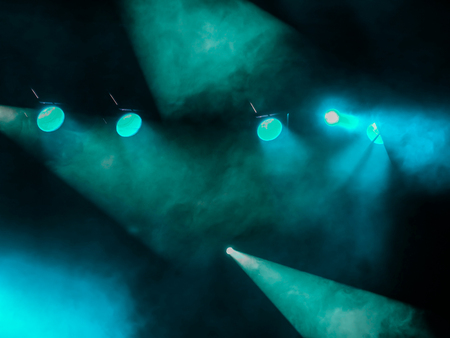 Lighting equipment on the stage. The spotlight through the smoke. Theater performance.