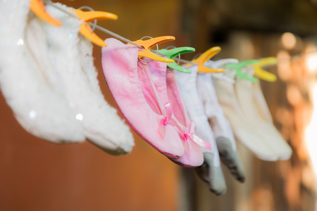 Children's ballet shoes are drying on a rope.の写真素材
