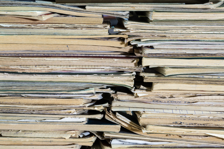 A stack of old school notebooks. Multicolored cover.