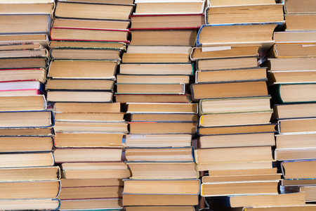 A stack of books with colorful covers. The library or bookstore. Books or textbooks. Education and reading.の写真素材
