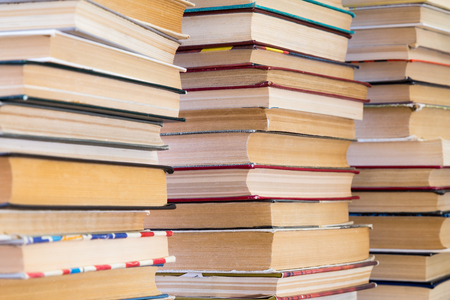 A stack of books with colorful covers. The library or bookstore. Books or textbooks. Education and reading.の写真素材