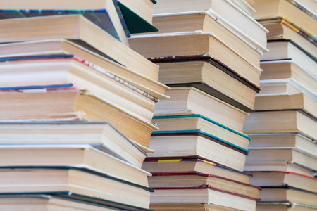 A stack of books with colorful covers. The library or bookstore. Books or textbooks. Education and reading.の写真素材