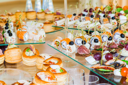 Snacks, fish and meat specialties on the buffet. A gala reception. Served tables. Catering.の写真素材
