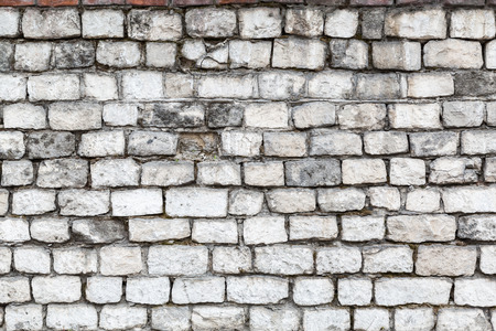 The old stone walls. The brick wall of the house. Gray textured background. Abstraction.の写真素材