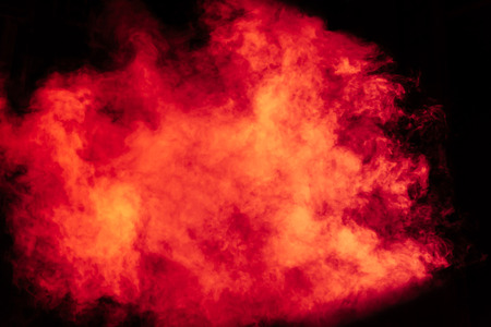 Red and yellow theatrical smoke on stage. Lighting equipment.の写真素材