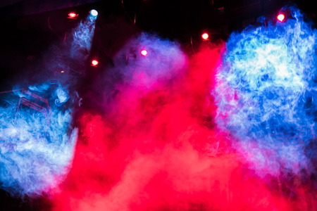 Blue and red smoke smoke on stage. Lighting equipment. Theatrical performance or show.の写真素材