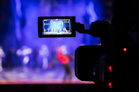 Filming the show from the auditorium. LCD viewfinder on the camcorder.の写真素材
