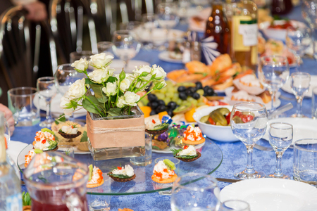The people at the Banquet. A solemn event in the enterprise. Anniversary or wedding. Snacks and alcohol on the tables. Served buffet style. Catering.の写真素材