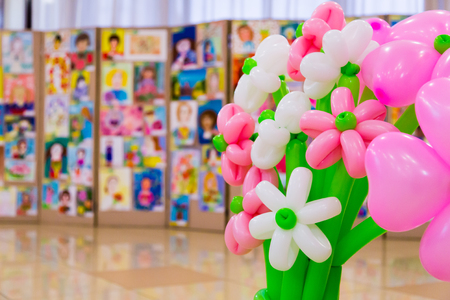 Competition of children's drawings. Exhibition of children's art. Colorful balloons in the foreground. Defocused background.の写真素材