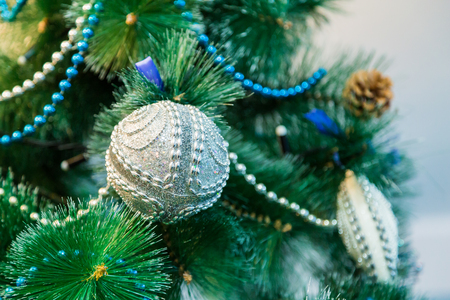 Decorated Christmas tree with blue lights. White Christmas ball and garland.の写真素材