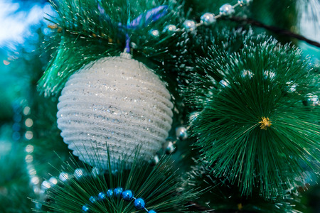 Decorated Christmas tree with blue lights. White Christmas ball and garland.の写真素材