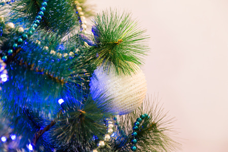 Decorated Christmas tree with blue lights. White Christmas ball and garland.の写真素材