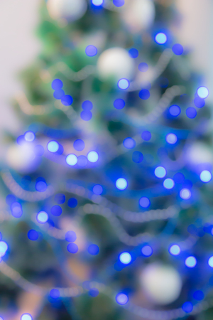 Decorated Christmas tree with blue lights. Unfocused imageの写真素材