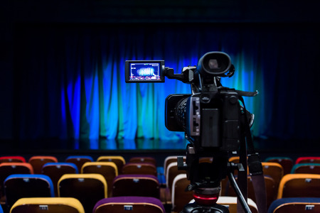 The LCD display on the camcorder. Videography in the theater. Blue-green curtain on the stage.の写真素材