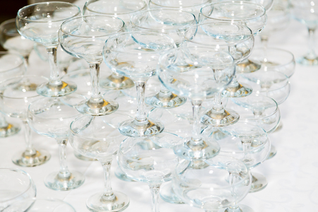 Many empty champagne glasses on the table in the restaurant.の写真素材