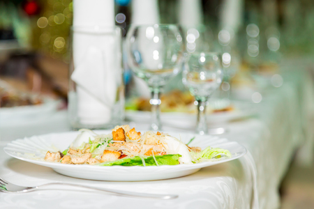 Salad in plate and Cutlery for the Banquet table. A solemn event. Catering.の写真素材