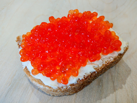 Sandwich with red caviar. White bread with butter. Seafood delicacies.の写真素材