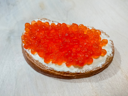 Sandwich with red caviar. White bread with butter. Seafood delicacies.の写真素材