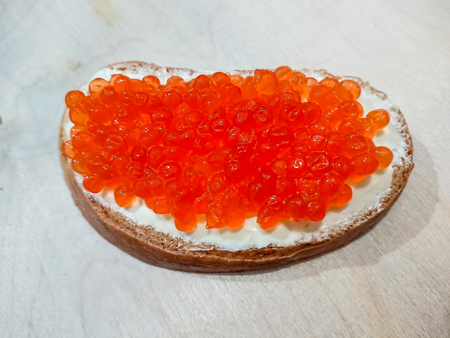 Sandwich with red caviar. White bread with butter. Seafood delicacies.の写真素材