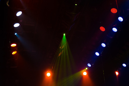Lighting equipment on the stage of a theater or concert hall. The rays of light from spotlights.