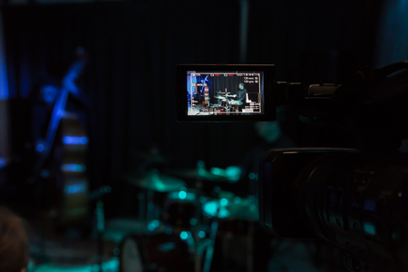 LCD display on the camcorder. Filming of the concert. Musicians playing the double bass and drumsの写真素材