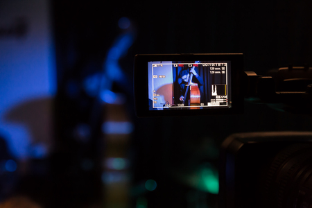 LCD display on the camcorder. Filming of the concert. The musician plays the double bassの写真素材