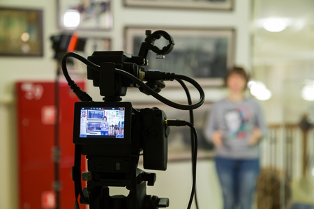TV shooting at the Museum. LCD monitor on the camcorder. The girl in front of the camera. A record...