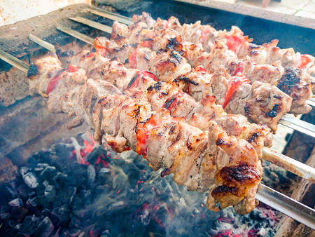 Cooking barbecue pork on the coals. Roasted meat. Junk food.の写真素材