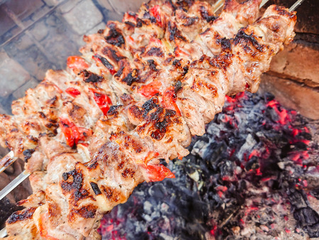 Cooking barbecue pork on the coals. Roasted meat. Junk food.の写真素材