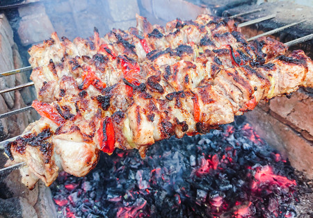 Cooking barbecue pork on the coals. Roasted meat. Junk food.の写真素材