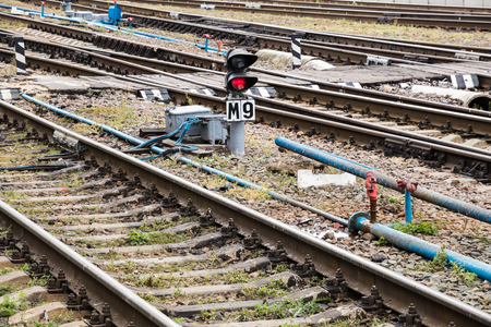 Railway tracks and red lights near the station. Rails and sleepers.の写真素材