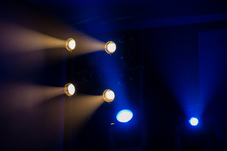 Theater lighting equipment. The light rays from the spotlight through theatrical smoke.