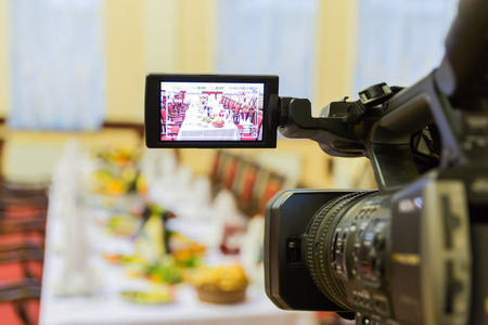 Video shooting at a restaurant at a Banquet. Camcorder with LCD display.の写真素材