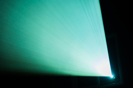 A beam of light from the projector in the cinema. Theater equipment. Abstract background.