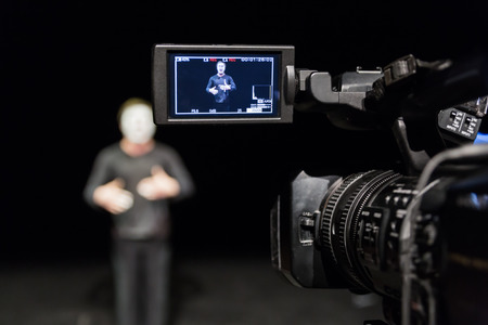 Actor in front of the camera. LCD display on the camcorder. Filming in the interior.の写真素材