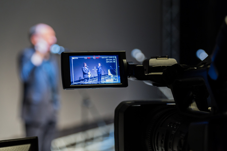 Video shooting of the event. Camcorder with LCD display. Microphones on a gray screen background.の写真素材