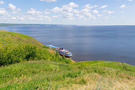 Picturesque river landscape. Four-deck cruise ship at the pier. The view from the top. Volga River, Russia, Tatarstan.の写真素材