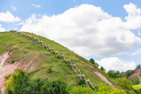 Stairs to the mountain. The hilly Bank of the Volga in Tetyushi, Tatarstan, Russia. Sunny summer day. White clouds in a blue sky.の写真素材