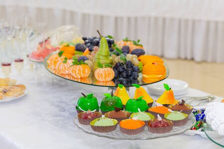 Various fruits, desserts, pastries on the holiday table. New year or Christmas.の写真素材