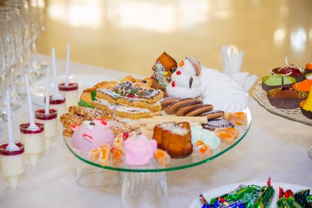 Various fruits, desserts, pastries on the holiday table. New year or Christmas.の写真素材