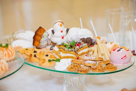 Various fruits, desserts, pastries on the holiday table. New year or Christmas.の写真素材