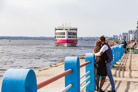 Saratov, Russia - September 21, 2020: The river cruise ship "Mustai Karim" of the PV300 project sails to the pier. Russian shipping company "Vodohod". People on the embankment meet the shipのeditorial素材