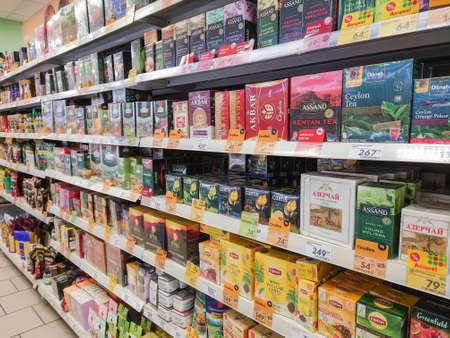 Saratov, Russia - December 18, 2021: Tea in cardboard boxes on the shelves of a food supermarket.のeditorial素材