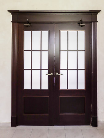 Stylized wooden door with glass inserts in the apartment.の写真素材