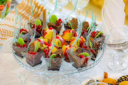 Cakes, fruits and desserts on the buffet. Luxurious table setting at the banquet. restaurant service. Catering.の写真素材