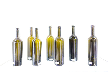 Empty bottles of wine on a white background alignedの写真素材