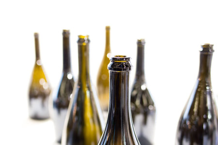 Empty bottles of wine on a white background alignedの写真素材