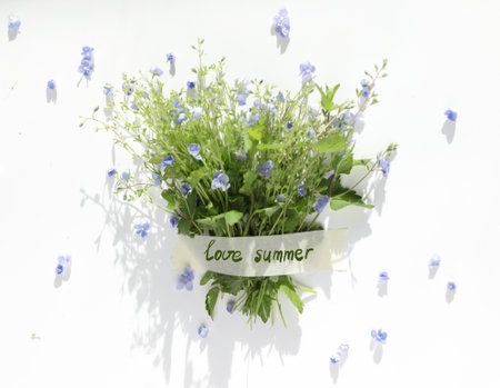 Cute Summer bouquet of small flowers of blue forget-me-nots with juicy green leaves, with the text...