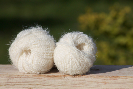 white balls of soft wool on wooden boardの写真素材